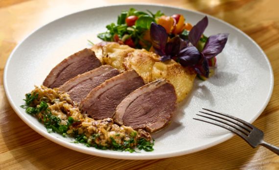 Roasted goose with homemade pierogi,  sun-dried tomato sauce, mix salad